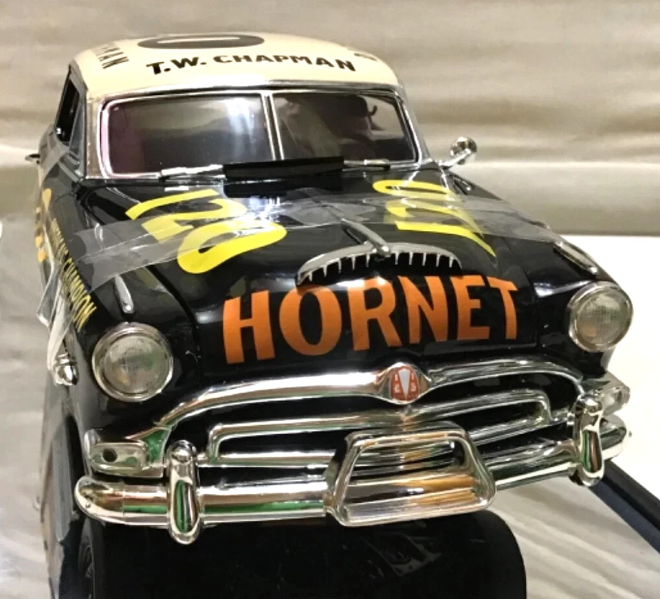 Hornet Race Car Model Black and cream Hornet race car model shown from the front, with yellow hood markings and orange HORNET lettering.